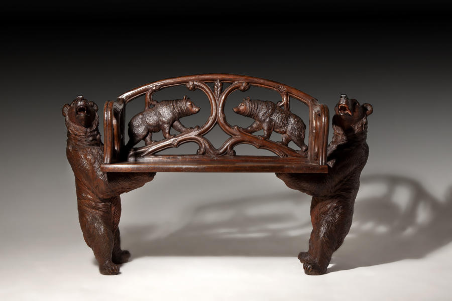 An exceptional carved linden wood "Black Forest" love seat