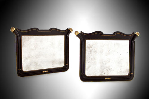 A fabulous pair of 19th century black and gold overmantel mirrors