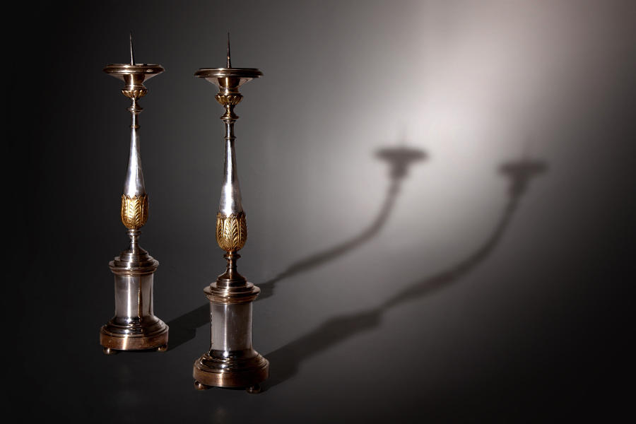 A tall pair of silvered and gilded pricket candlesticks