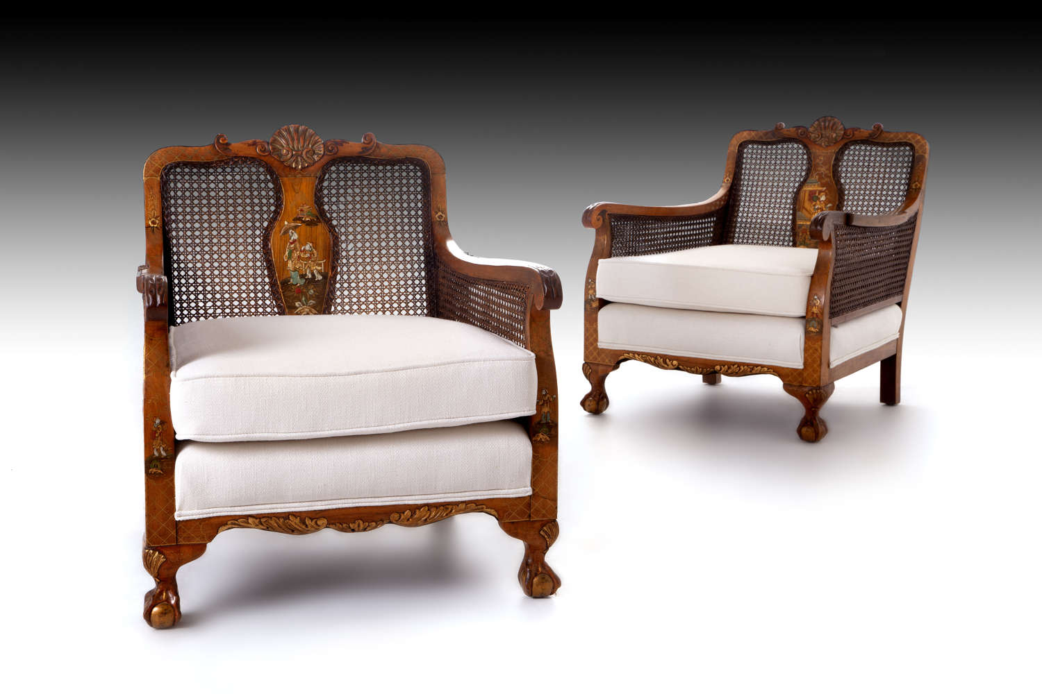 A pair of walnut and chinoiserie caned bergere chairs and  settee
