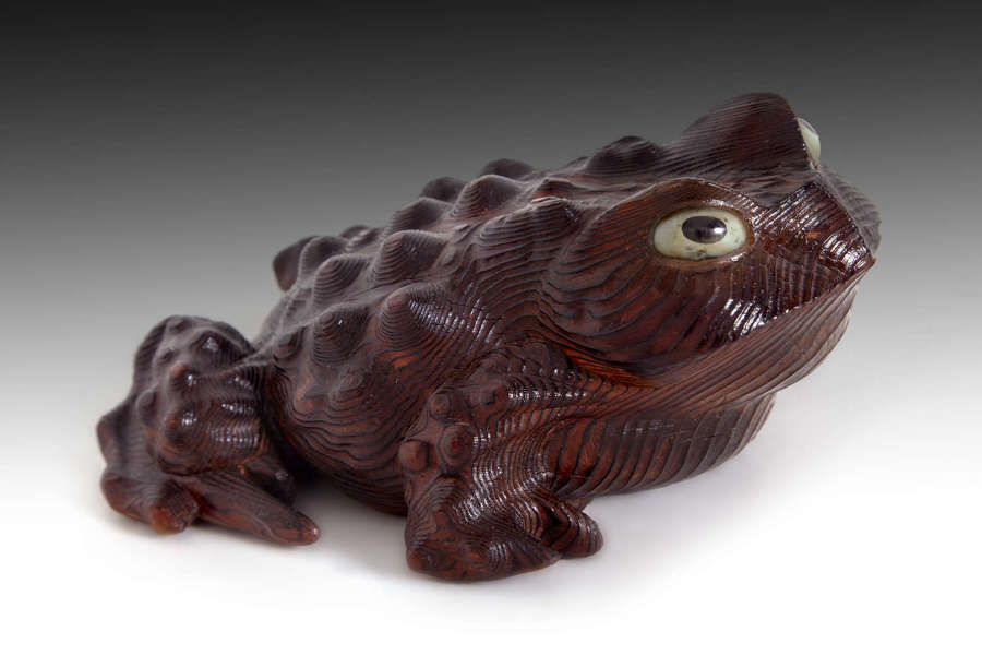 A carved wooden toad