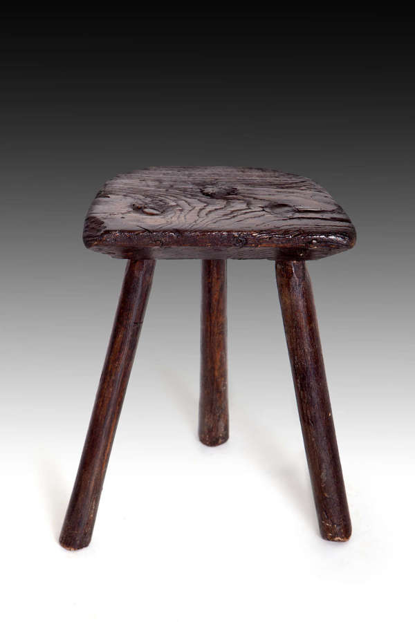 A small oak milking stool
