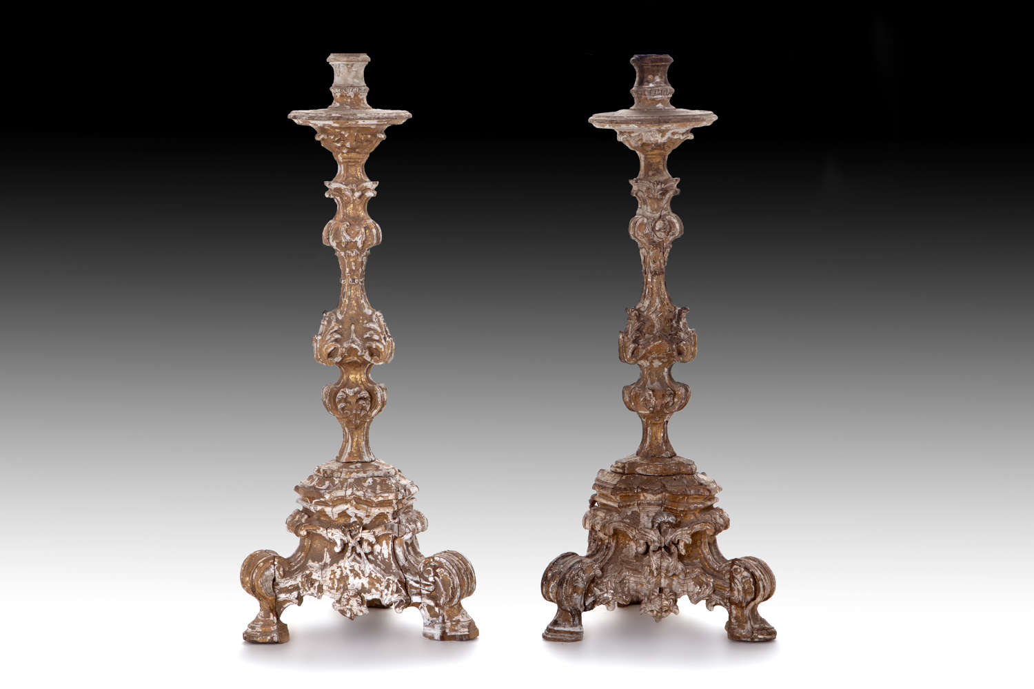 A pair of late 17th century giltwood candlesticks