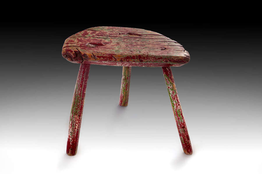 An early 19th century painted milking stool