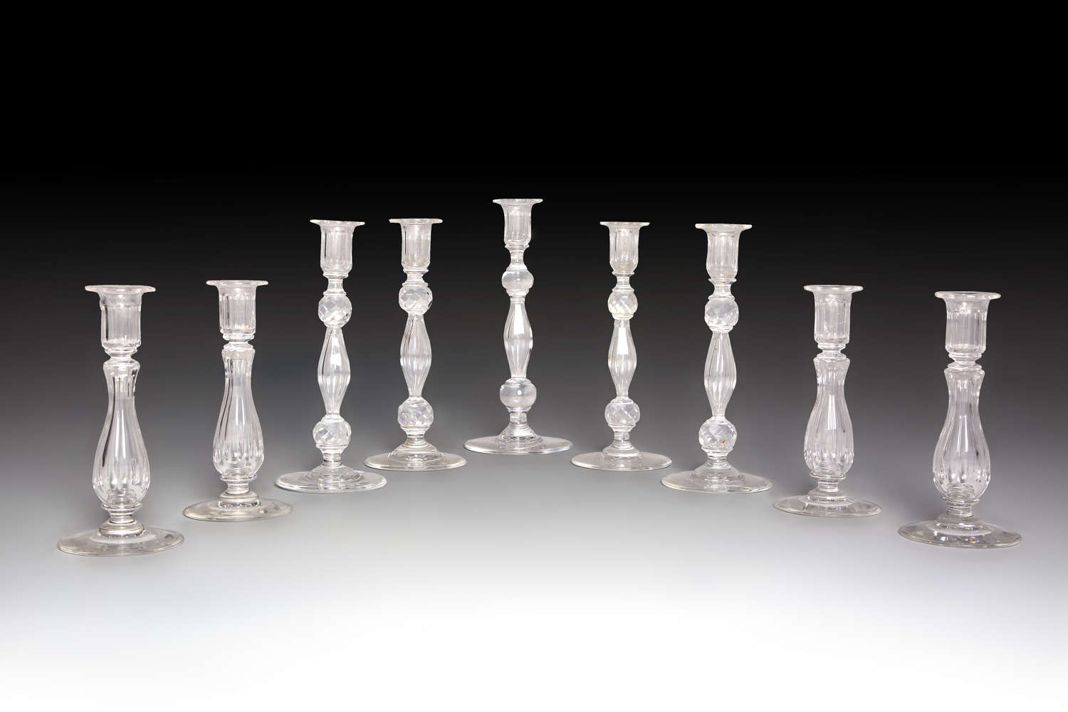 A collection of glass candlesticks