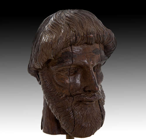 A finely carved 17th century head of a scholar