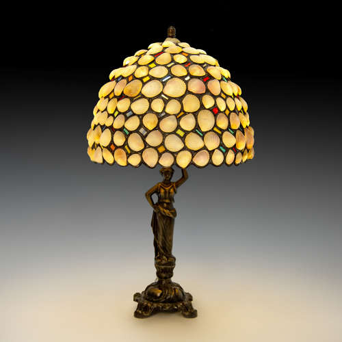 A bronze and shellwork lamp