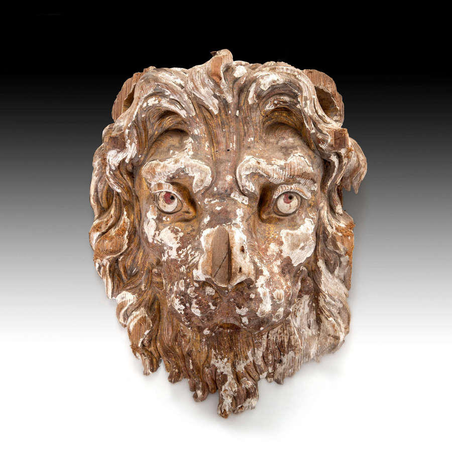 A large scale 18th century carved giltwood lions head
