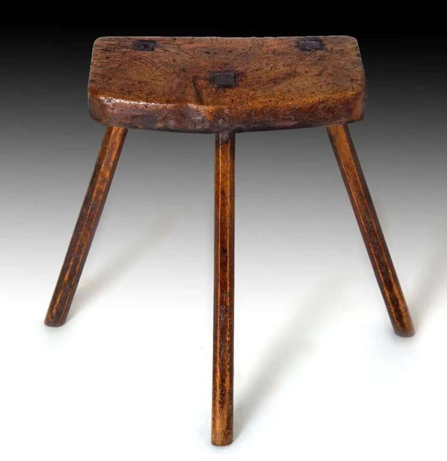 An early 19th century elm and ash stool