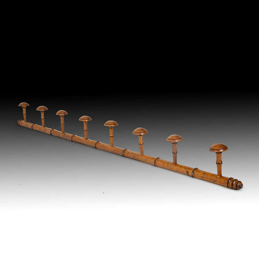 A carved stylised bamboo hat rack