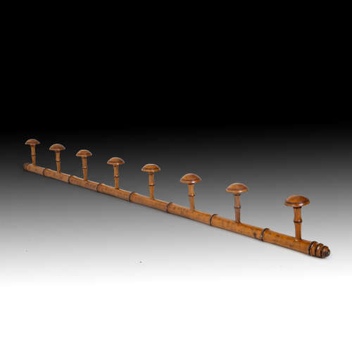 A carved stylised bamboo hat rack