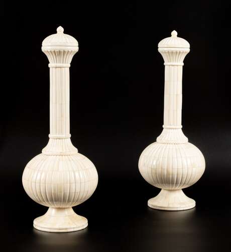 A fine pair of carved bone vases and covers